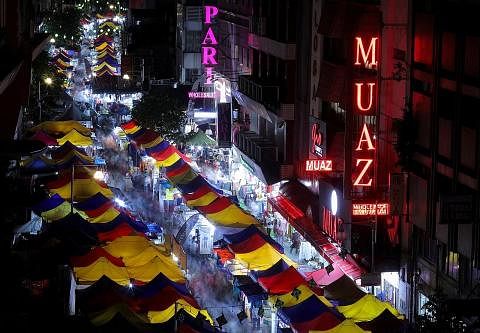 PENIAGA BAZAR TURUT TERJEJAS: Dek pengumuman Raya mengejut, peniaga bazar Raya di Malaysia rata-rata terpaksa melelong barangan mereka sehari lebih awal yang dijadualkan. - Foto REUTERS