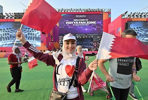 TIADA DITANGKAP: Seorang peminat bola sepak mengibarkan bendera Qatar sebelum tayangan langsung perlawanan negara itu menentang Ecuador. Buat kali pertama dalam sejarah Piala Dunia, tiada penyokong England ditangkap kerana berkelakuan tidak senonoh a