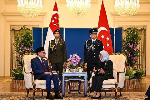 KERJASAMA KUKUH: Puan Halimah dan Datuk Anwar, yang bertemu di Istana semalam, antara lain berbincang tentang kerjasama antara Singapura dengan Malaysia, termasuk dalam bidang baru.