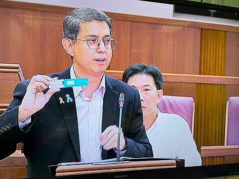 LEBIH RINGAN: Profesor Madya Dr Muhammad Faishal tunjukkan kit ujian air liur yang mencegah warga Singapura dan penduduk tetap (PR) daripada menyalah guna dadah di luar negara. - Foto BH oleh FARID HAMZAH