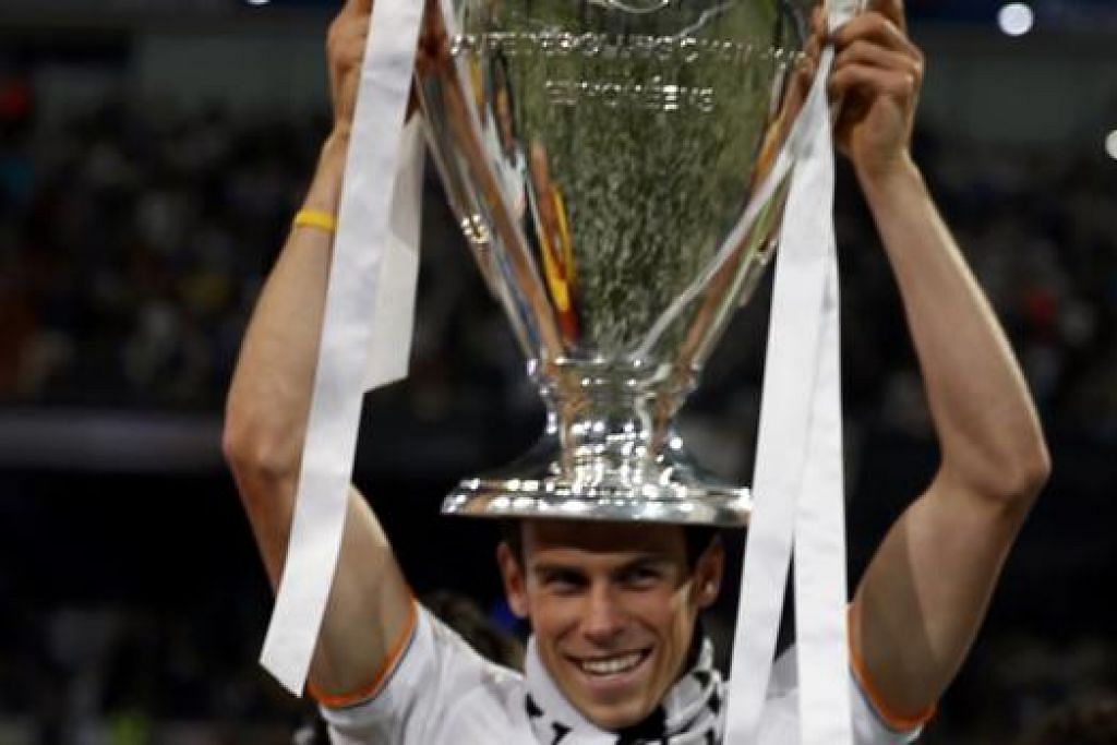 PENGALAMAN HEBAT: Bintang Real Madrid, Gareth Bale, meraikan trofi kejuaraan Liga Juara-Juara dalam musim sulungnya sejak berpindah ke kelab gergasi La Liga itu. Bale, bagaimanapun, tidak berpeluang menayangkan kehebatannya di Piala Dunia kerana negaranya, Wales, gagal melayakkan diri ke Brazil. - Foto REUTERS 