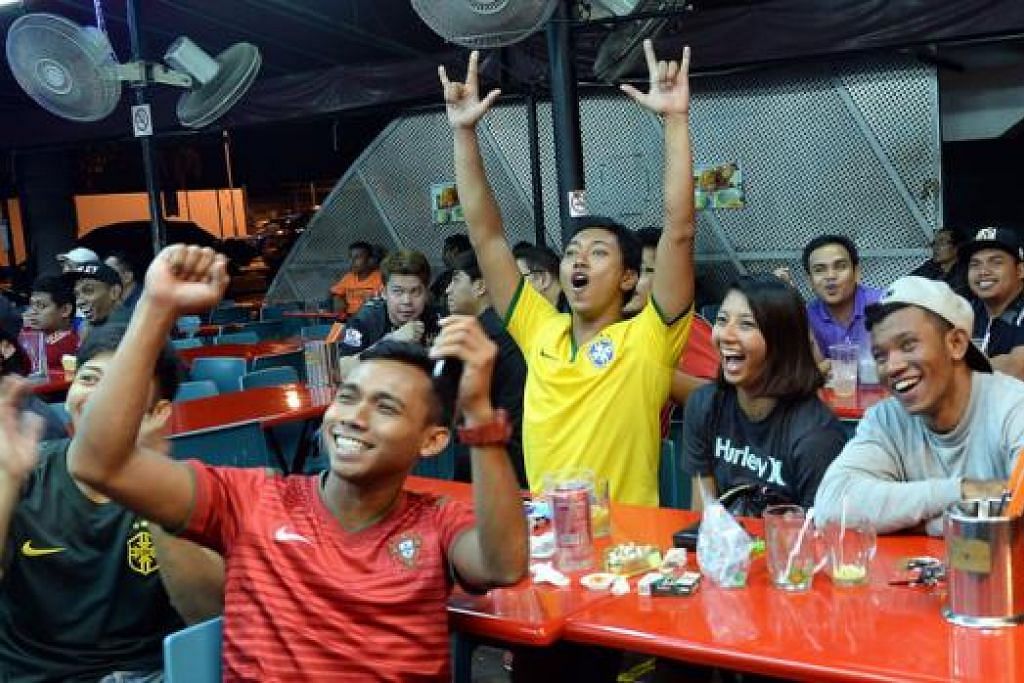 GOL!: Penyokong di restoran Enak-Enak Hongkong Tea House di Simpang Bedok meraikan gol terakhir Brazil. Beberapa pusat makanan yang berhampiran juga menayangkan perlawanan bola sepak antara Brazil dan Croatia.