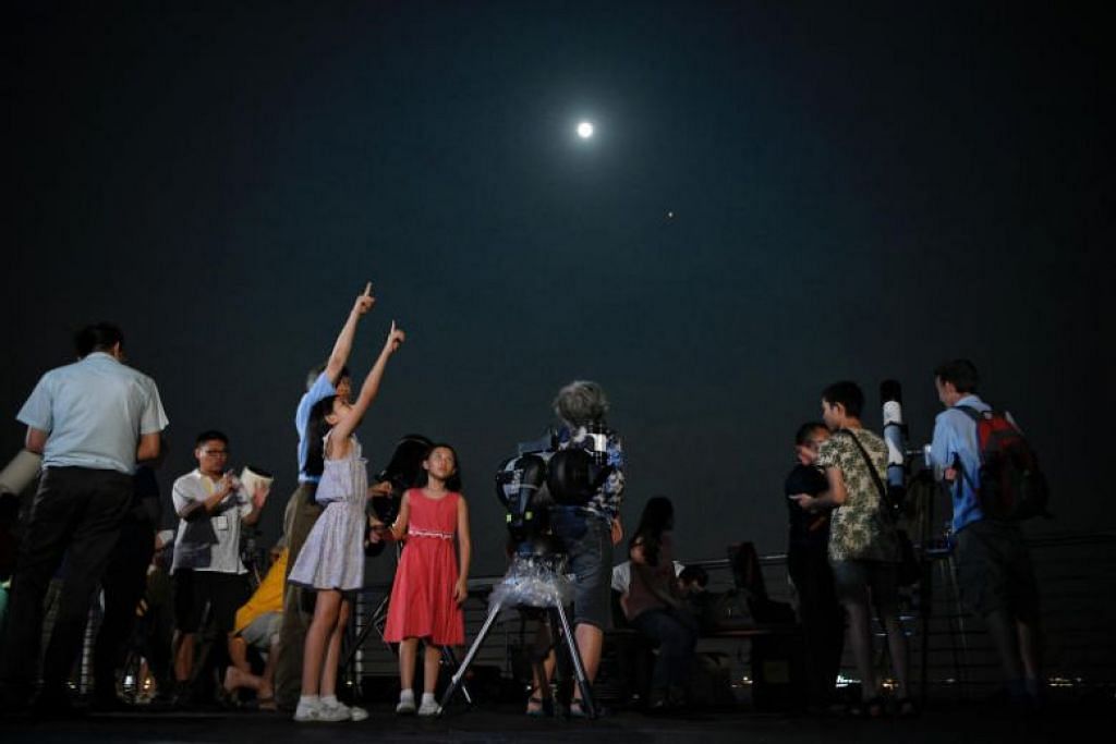 Lunar eclipse: Stargazers in Singapore catch century's longest 'blood moon'