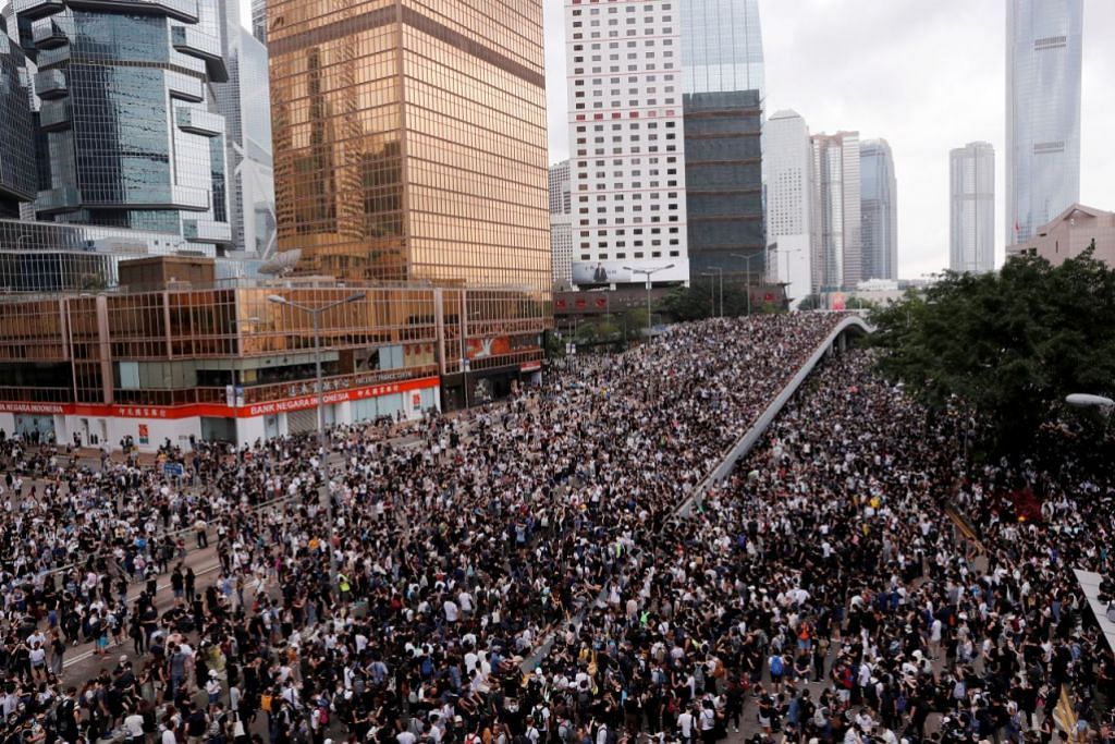 Hong Kong delays debate on extradition Bill as thousands of protesters block key roads
