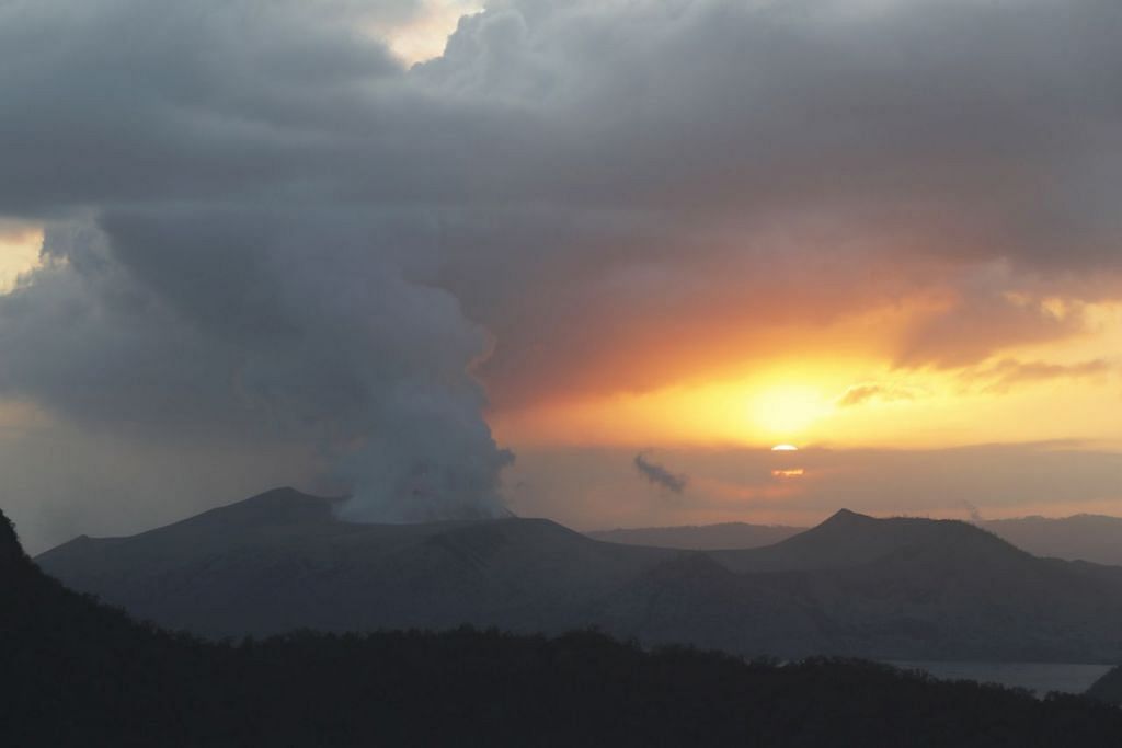 CANTIK TAPI BAHAYA: Di sebalik pemandangan indah matahari terbenam, Gunung Berapi Taal mengeluarkan asap tebal yang menjejas kawasan berdekatan gunung yang terletak di wilayah Batangas itu. - Foto EPA-EFE