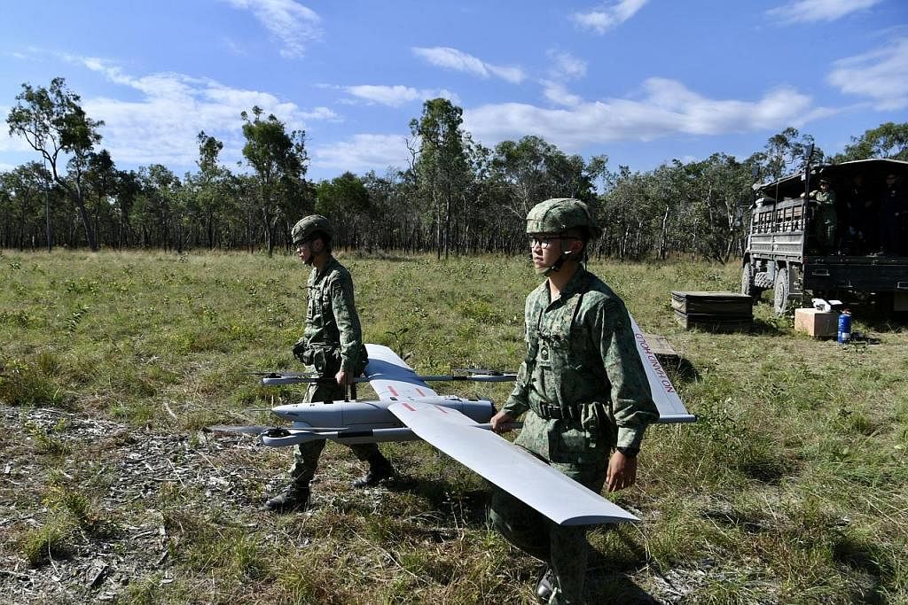 USAHA PERISIKAN: Dua anggota SAF kelihatan menyediakan UAV V-15 di satu kawasan latihan di Shoalwater Bay, Queensland, Australia kelmarin. - Foto BH oleh DESMOND FOO