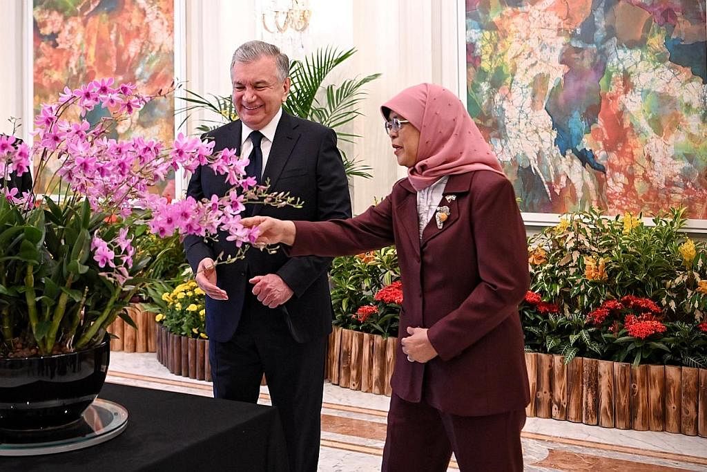 PERKUKUH HUBUNGAN: Encik Mirziyoyev (kiri) dan Encik Lee di majlis menandatangani MOU di Istana semalam. - Foto-foto BH oleh KUA CHEE SIONG KUNJUNGAN KE ISTANA: Puan Halimah dan Encik Mirziyoyev sewaktu majlis menamakan orkid di Istana semalam.