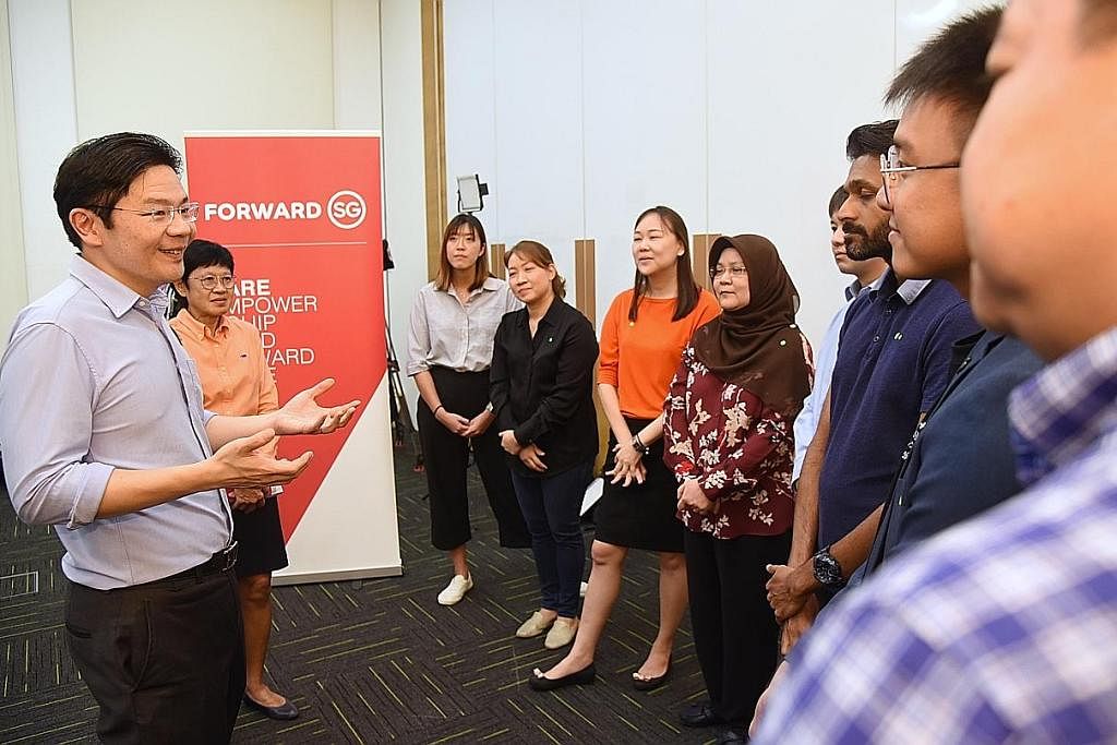 BINA KEPERCAYAAN: Encik Lawrence Wong mendekati pengamal perkhidmatan sosial untuk mendapatkan pandangan dan idea mereka sebagai sebahagian usaha Melakar Hala Tuju Singapura. - Foto fail
